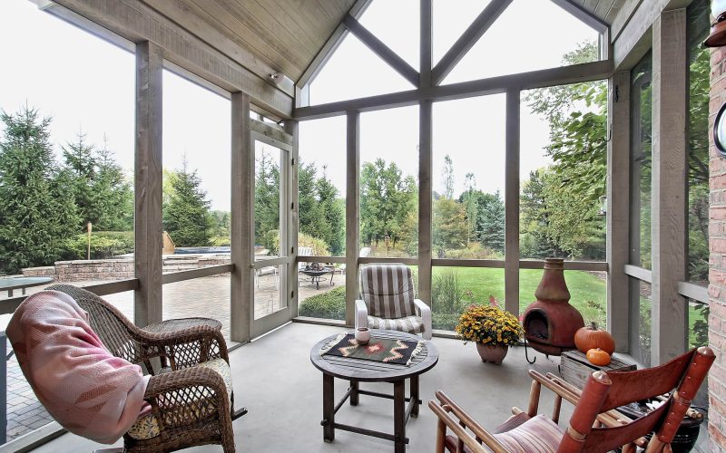 Screen porch in luxury home with patio view